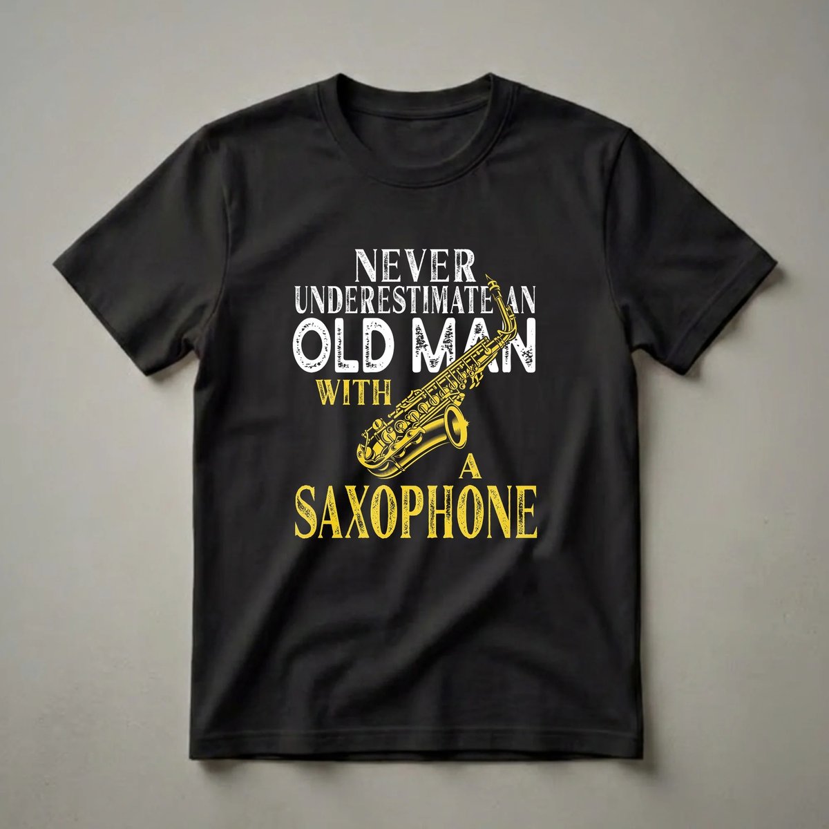 Black t-shirt with distressed white text reading 'Never Underestimate An Old Man With A Saxophone' and a yellow saxophone illustration.