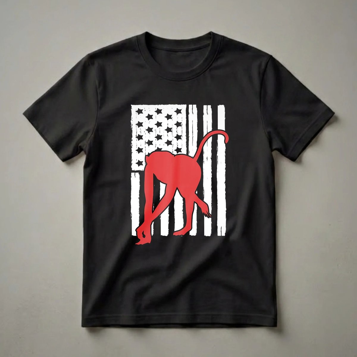 Red silhouette of a monkey on a distressed American flag background, on a black t-shirt.