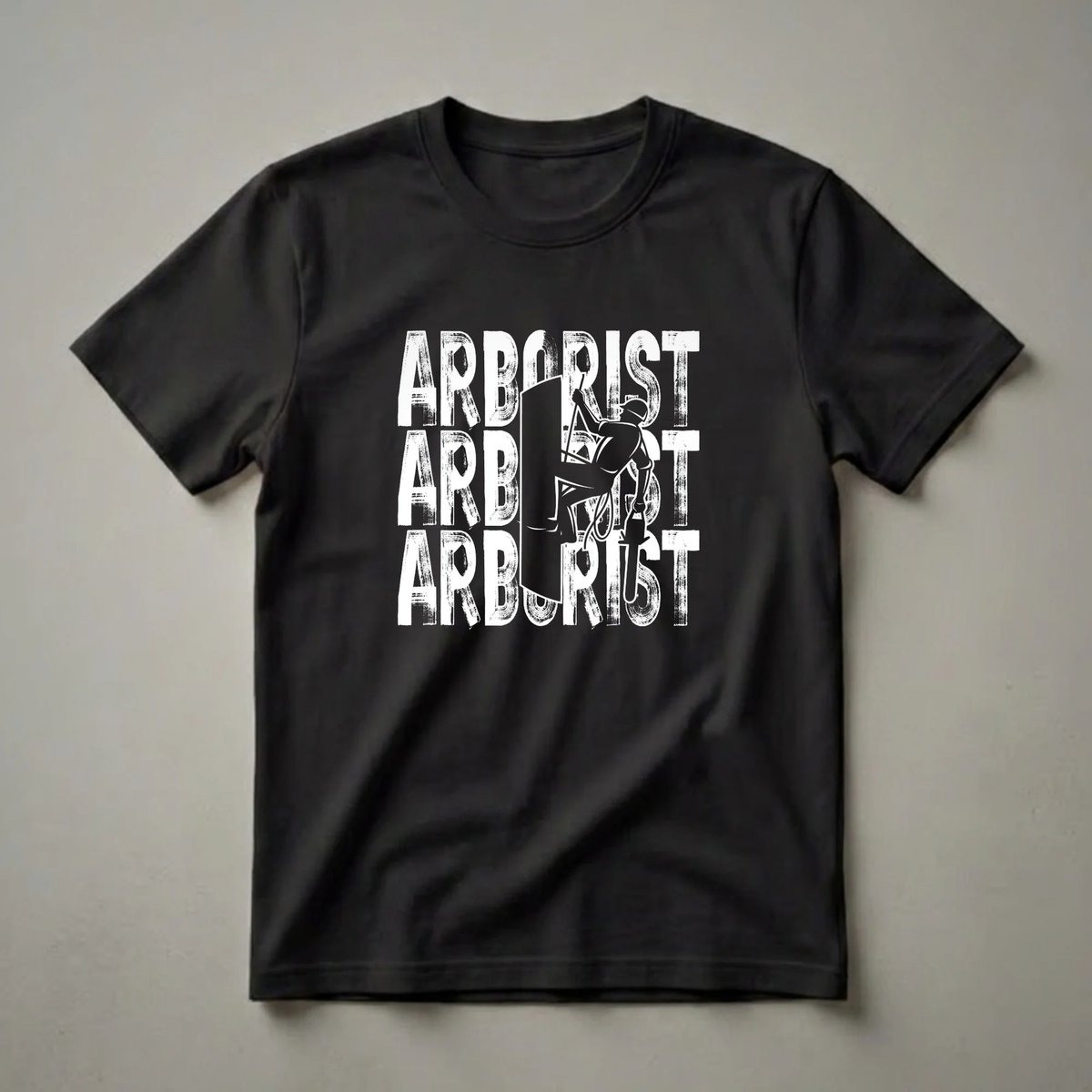 Black t-shirt with white distressed text 'ARBORIST' repeated, featuring a central silhouette of an arborist climbing a tree with ropes.
