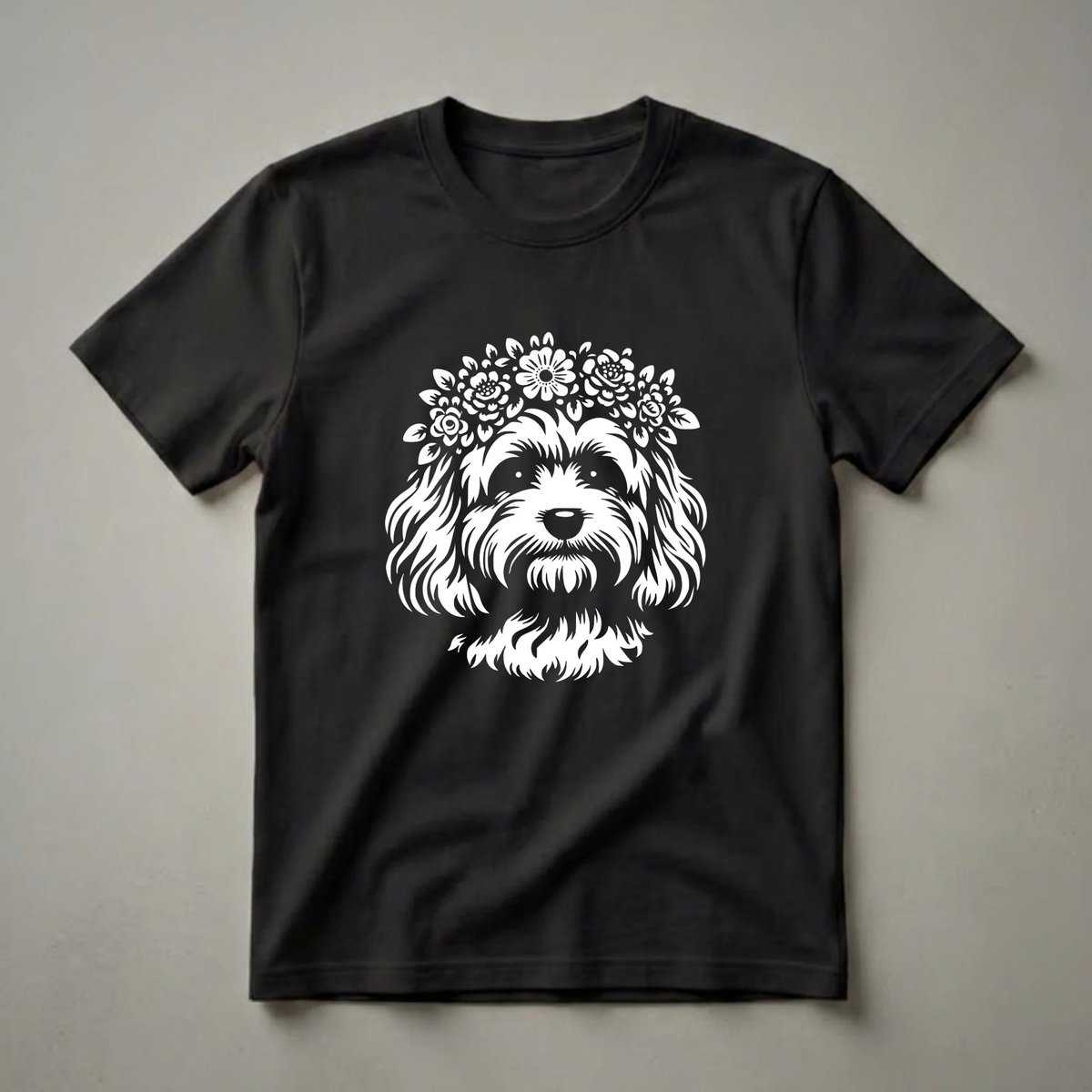 White stencil graphic of a Cavapoo dog wearing a delicate flower crown, printed on a black t-shirt.