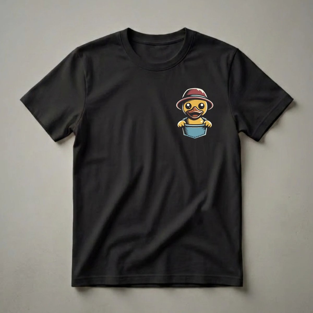 Yellow cartoon baby duck wearing a red and brown hat, peeking out of a blue pocket on a black shirt.