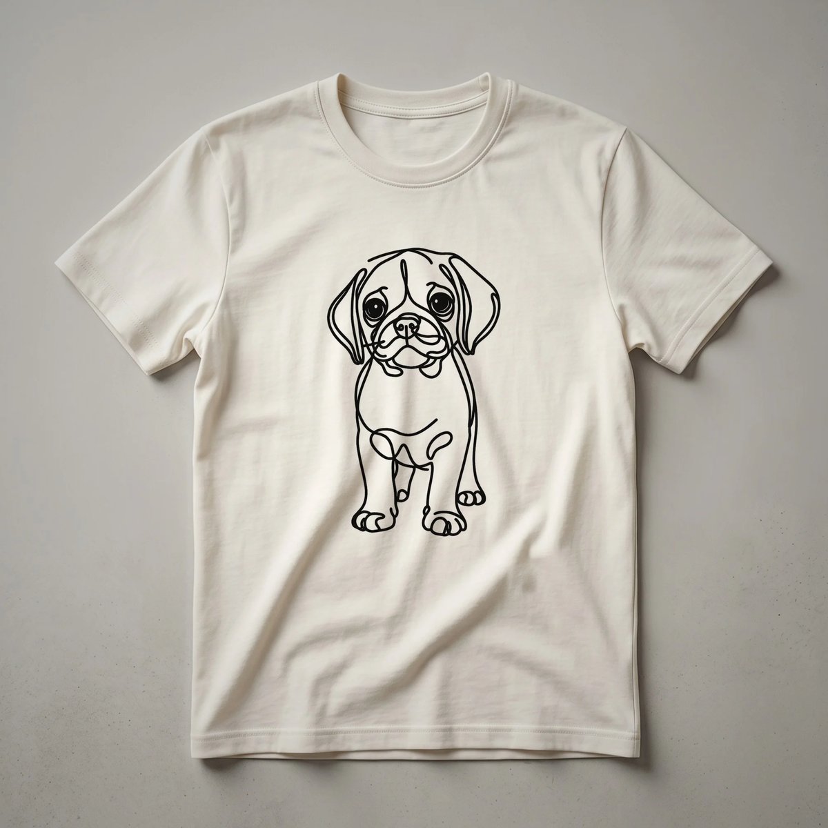 A white t-shirt featuring a black line art drawing of a Puggle dog's head and upper body.