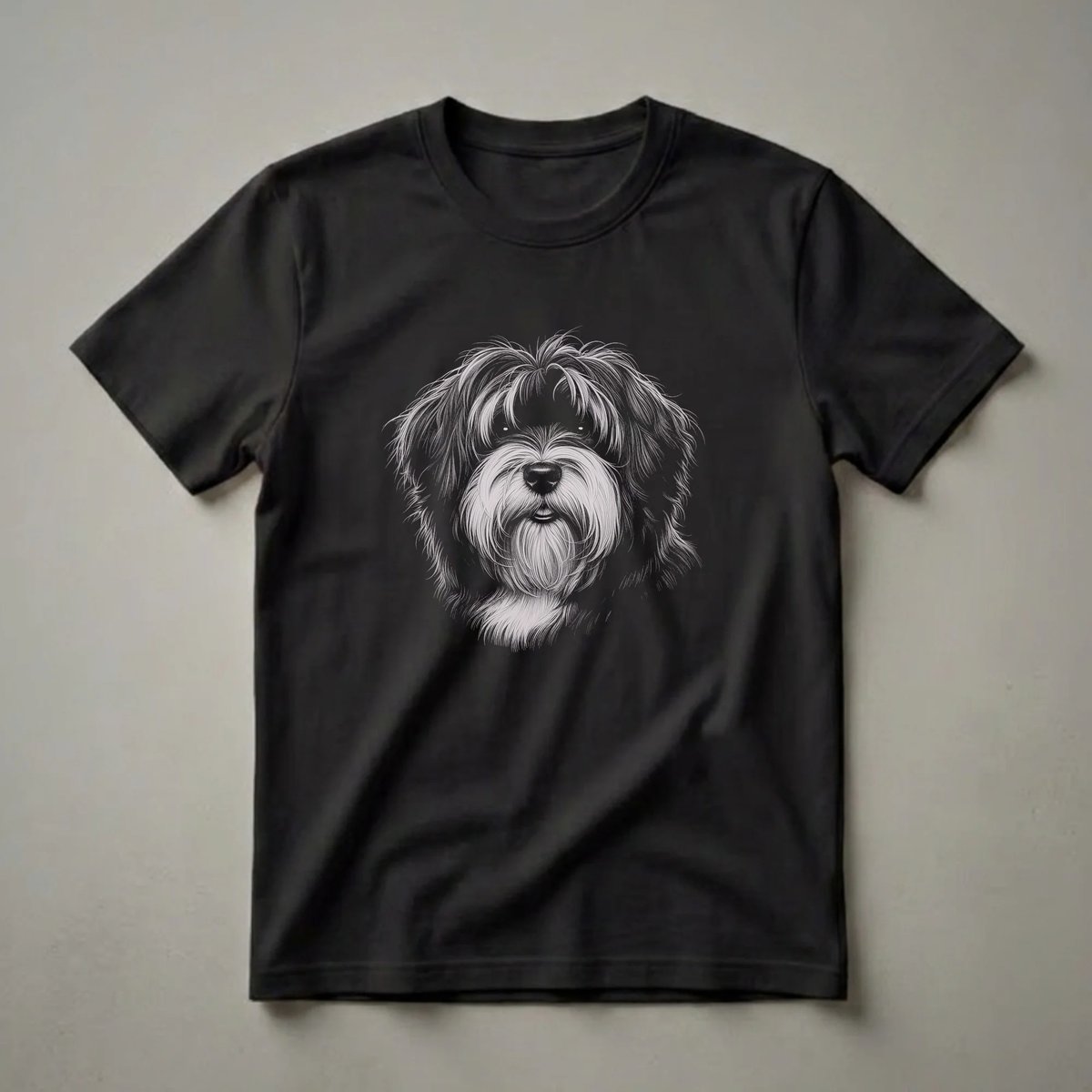 Black t-shirt featuring a detailed white and grey line drawing of a Tibetan Terrier's face with shaggy fur and expressive eyes.
