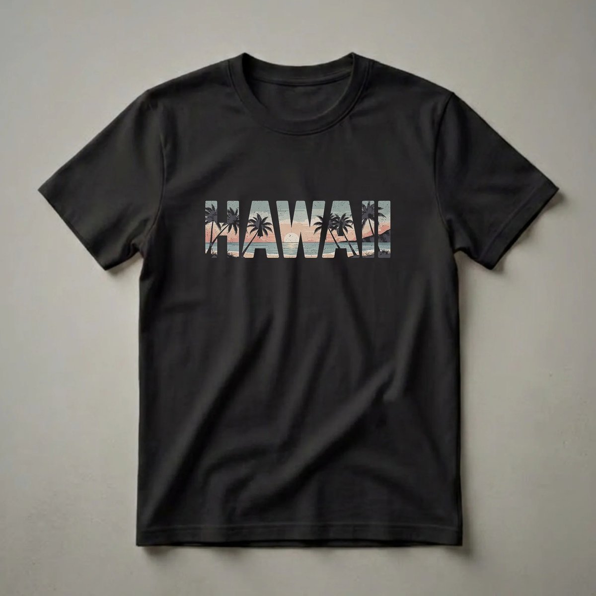 Black t-shirt featuring the word HAWAII filled with a retro sunset beach scene, complete with palm trees, ocean, and sand.