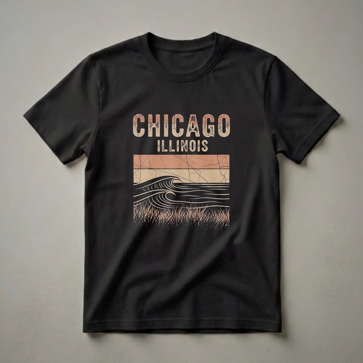 Black t-shirt with a retro graphic design featuring the words CHICAGO ILLINOIS above stylized waves and grass in beige and rust colors.