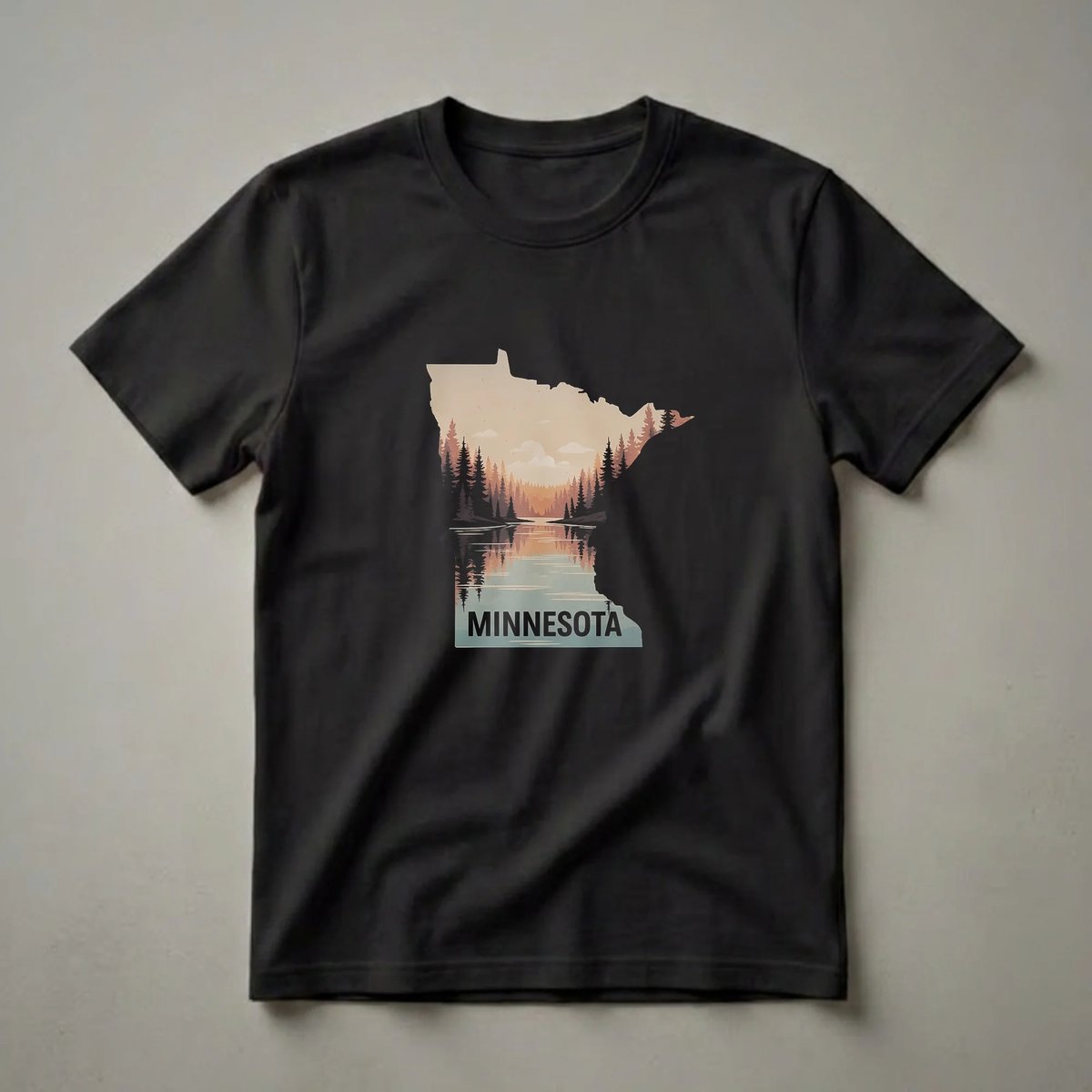 Black t-shirt with a graphic of the Minnesota state outline filled with a retro forest and lake landscape at sunset, with the word MINNESOTA at the bottom.