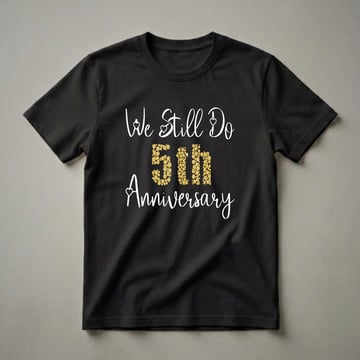 Black t-shirt with white script text 'We Still Do' and 'Anniversary', and gold bubble-filled text '5TH' in the center.