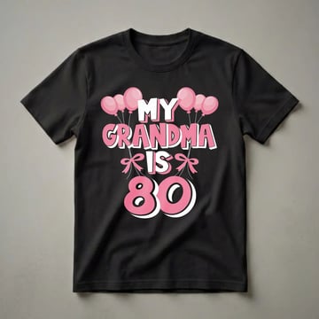 Black t-shirt with pink and white text that reads "MY GRANDMA IS 80" surrounded by pink balloons and bows, celebrating an 80th birthday.
