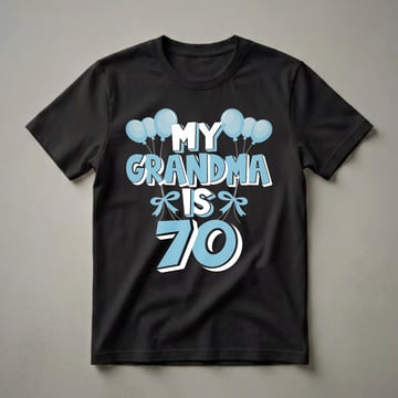Light blue and white graphic t-shirt with black background, featuring the text 'MY GRANDMA IS 70' surrounded by blue balloons and bows.