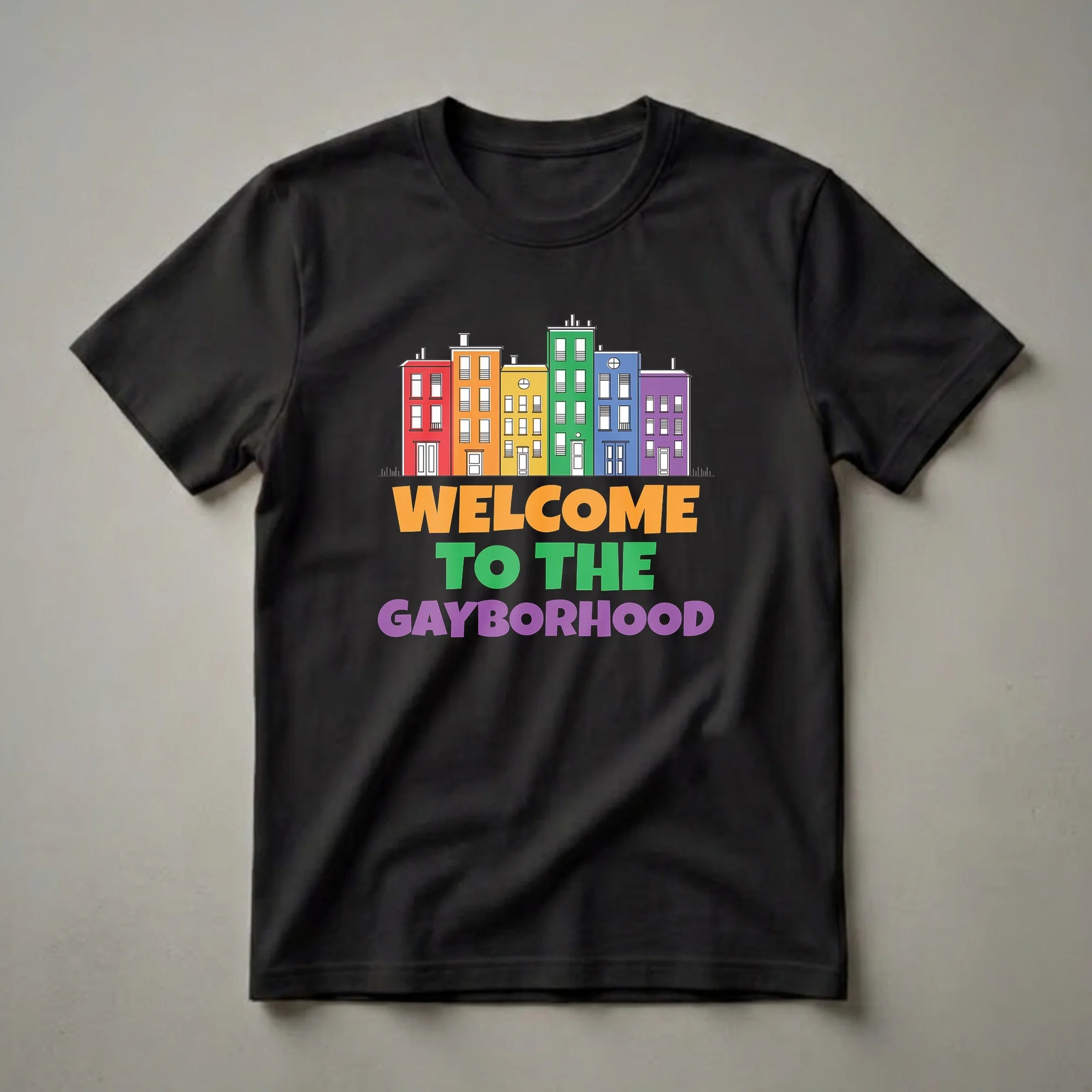 Black t-shirt with a graphic illustration of rainbow-colored buildings and the text 'Welcome To The Gayborhood' in bold, colorful letters.