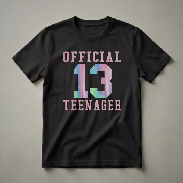 Black t-shirt with pink glitter text reading 'OFFICIAL TEENAGER' and a large watercolor number '13' in pink, blue, and green.