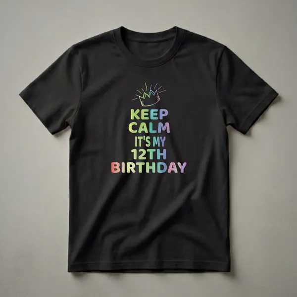 Black t-shirt with rainbow gradient text that reads 'KEEP CALM IT'S MY 12TH BIRTHDAY' and a sketched crown with radiating lines above.