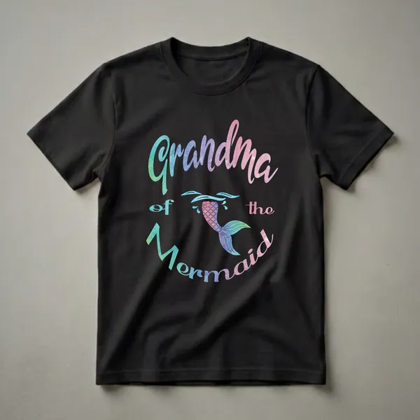 Black t-shirt with the text 'Grandma of the Mermaid' in a watercolor font, featuring a colorful mermaid tail graphic emerging from blue water splashes.