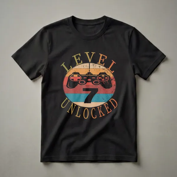 Black t-shirt with a vintage-style graphic featuring a black video game controller on a striped oval background, with the text 'LEVEL 7 UNLOCKED' in distressed fonts.
