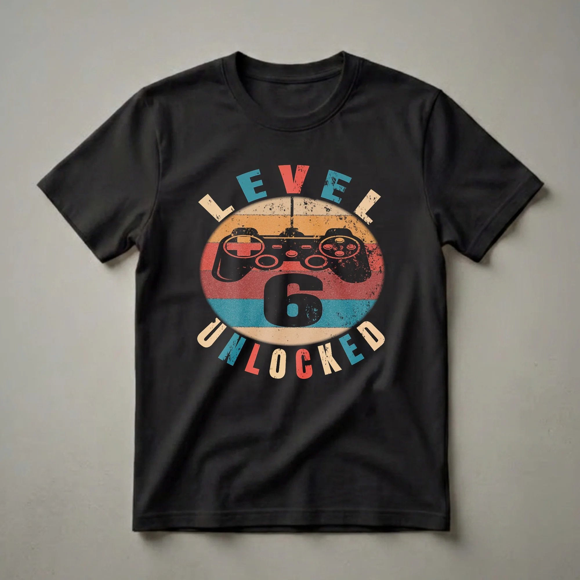 Black t-shirt with a graphic design featuring a vintage video game controller and the text 'LEVEL 6 UNLOCKED' in a distressed, retro style with a sunset color palette.