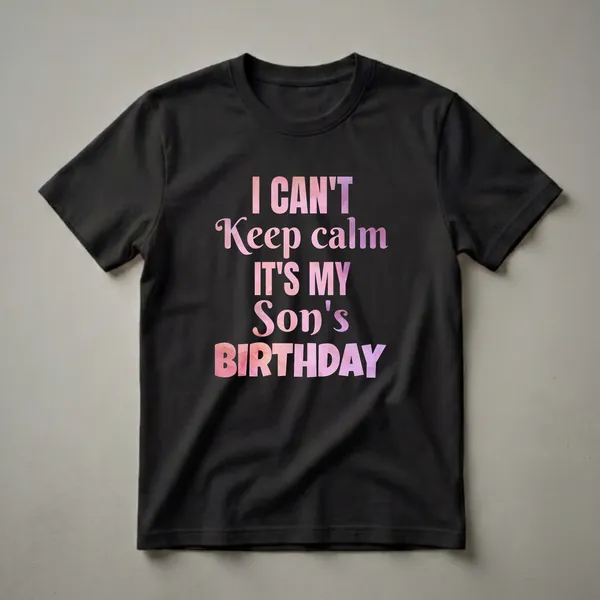 Black t-shirt with the text "I CAN'T Keep calm IT'S MY Son's BIRTHDAY" in large, watercolor-textured letters in shades of pink and purple.