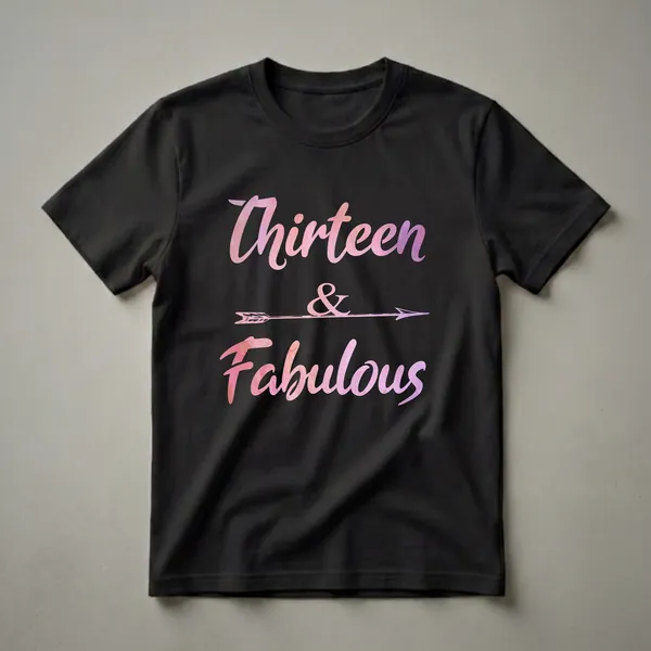 Black graphic t-shirt featuring the words "Thirteen & Fabulous" in a pink and purple watercolor font, with an arrow graphic in the center.