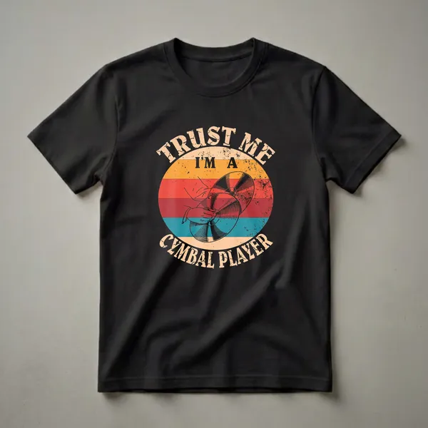 Black t-shirt with a graphic design featuring a hand striking cymbals within a retro sunset circle, with distressed text reading 'Trust Me I'm A Cymbal Player'.