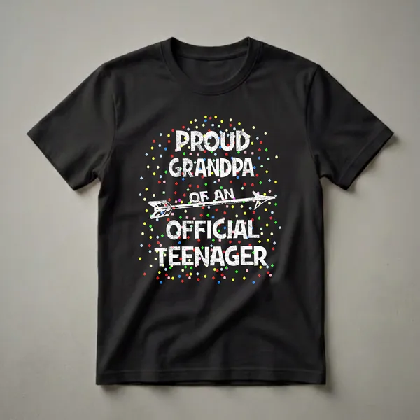 Black t-shirt with white distressed text reading 'Proud Grandpa of an Official Teenager' and a white arrow graphic, surrounded by colorful confetti.