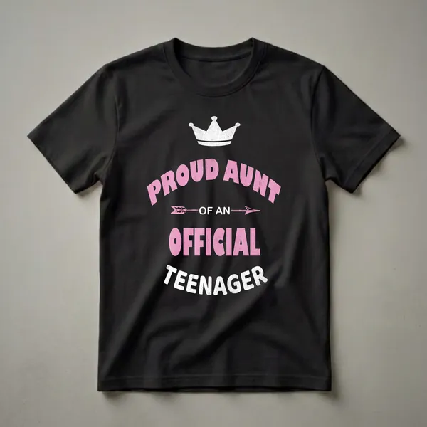 Black t-shirt with distressed pink and white text that reads 'Proud Aunt of an Official Teenager' with a crown and arrow graphic.