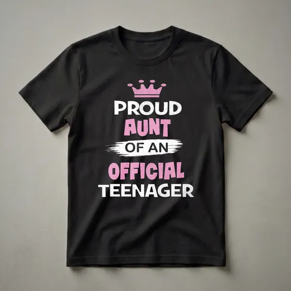 Black t-shirt with white and pink distressed text that reads 'Proud Aunt of an Official Teenager' and a pink crown graphic.