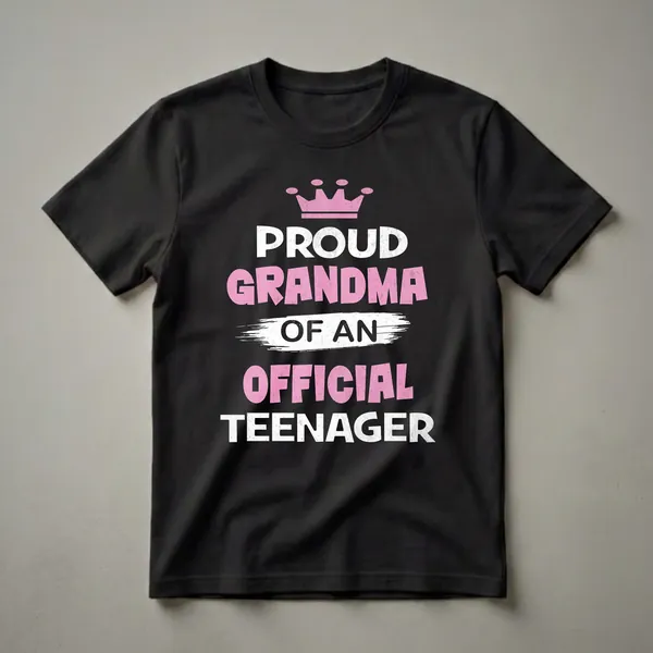 Black t-shirt with pink crown and distressed white and pink text reading 'Proud Grandma of an Official Teenager'.