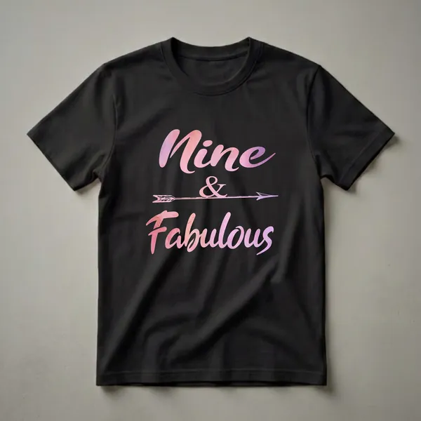 Black t-shirt with pink and purple watercolor text that reads 'Nine & Fabulous' with a decorative arrow.
