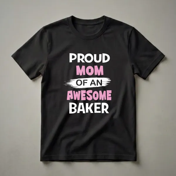 Black t-shirt with white and pink text that reads 'PROUD MOM OF A BAKER' with a white brush stroke graphic.