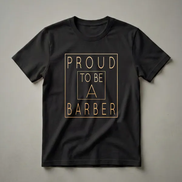 Black t-shirt with gold text that reads 'PROUD TO BE A BARBER' in a stylized font, enclosed within a golden border.