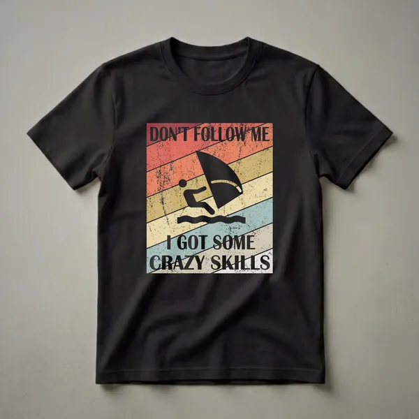 Black graphic t-shirt featuring a windsurfer silhouette on a retro striped background with the text 'DON'T FOLLOW ME I GOT SOME CRAZY SKILLS'.