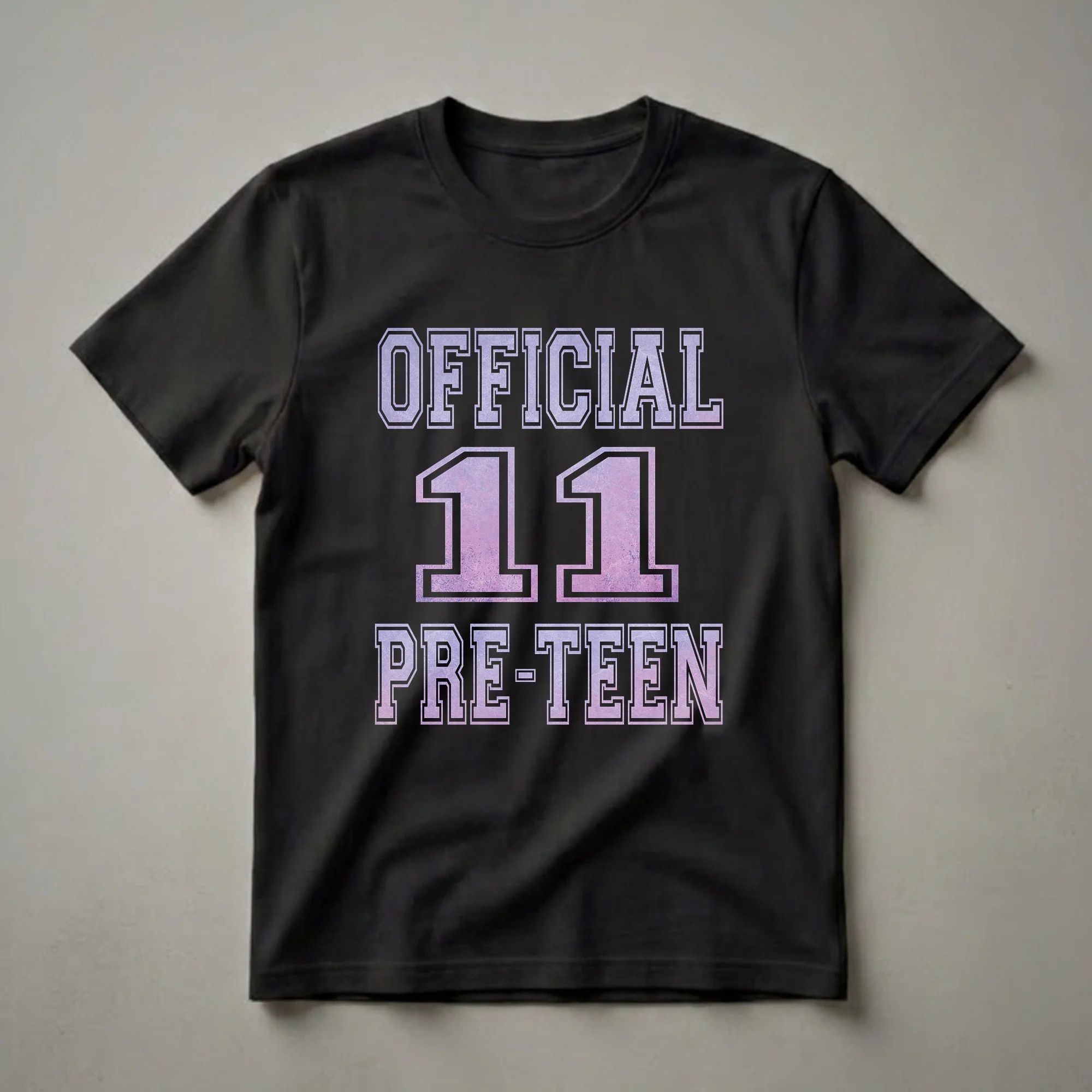 Black t-shirt with 'OFFICIAL 11 PRE-TEEN' graphic in a purple and pink gradient collegiate font with a distressed texture.