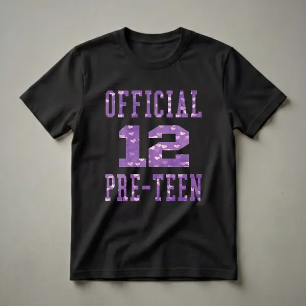 Black t-shirt with purple collegiate-style text that reads 'OFFICIAL 12 PRE-TEEN', with the letters filled with a watercolor pattern of pink and white hearts.