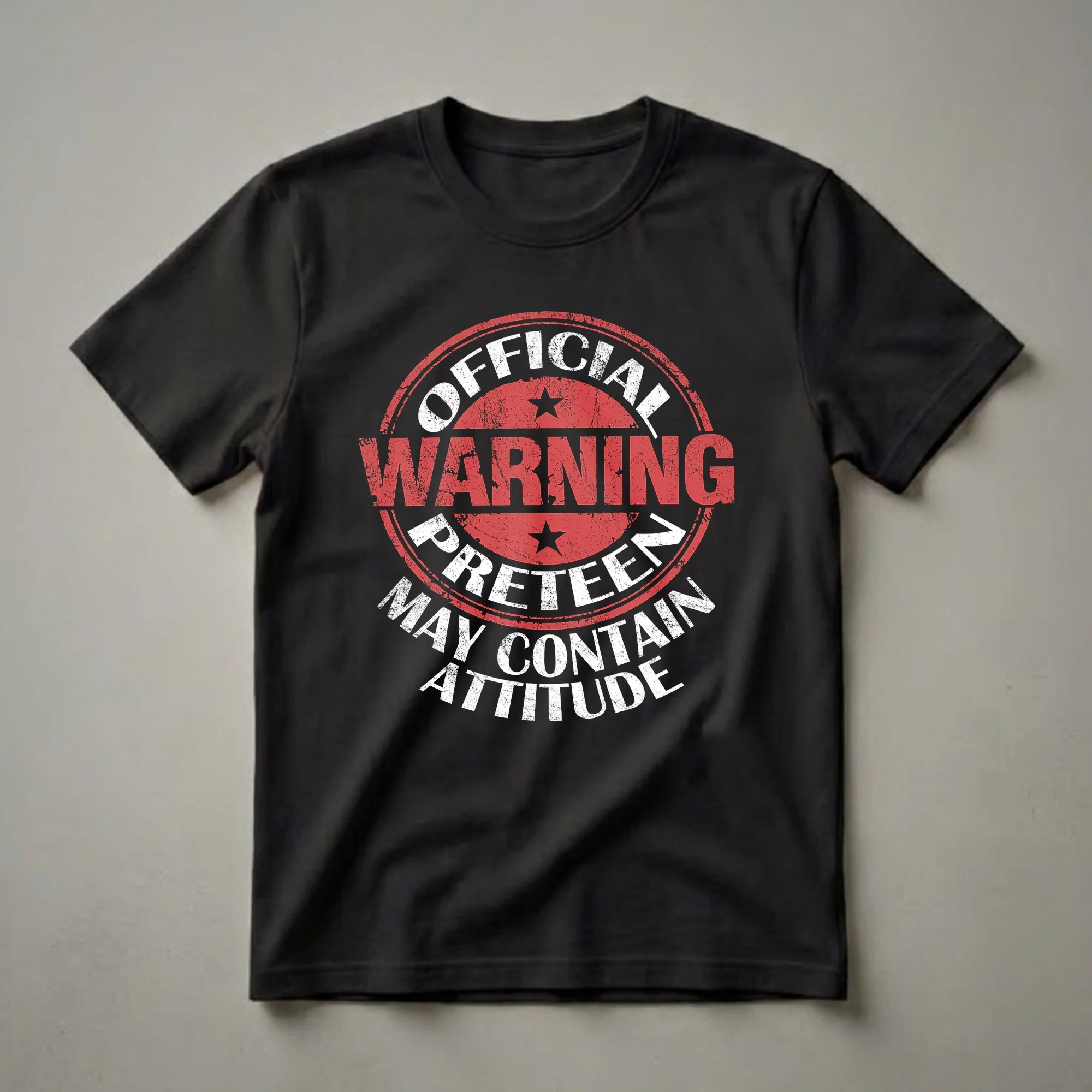 Black t-shirt with a distressed circular graphic featuring white and red text that reads "Official Preteen Warning May Contain Attitude".