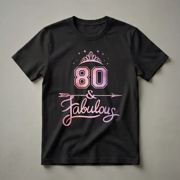 Black t-shirt featuring a pink and purple watercolor fill graphic with the number 80, a tiara, stars, an arrow, and the word 'Fabulous'.