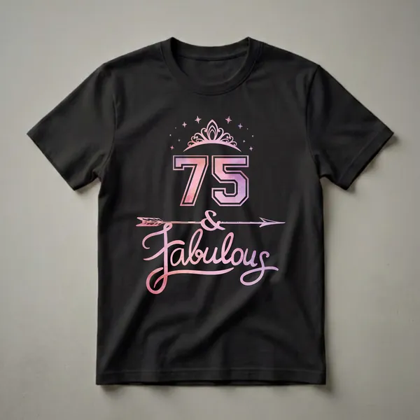 Black t-shirt with a graphic design featuring the number 75 in watercolor pink and purple, a tiara, stars, an arrow, and the word 'Fabulous'.