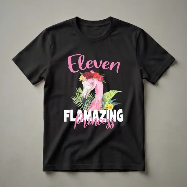 White shirt design with 'Eleven' in pink brush script, a floral-crowned pink flamingo surrounded by tropical leaves and yellow flowers, and 'Princess' in pink cursive below.