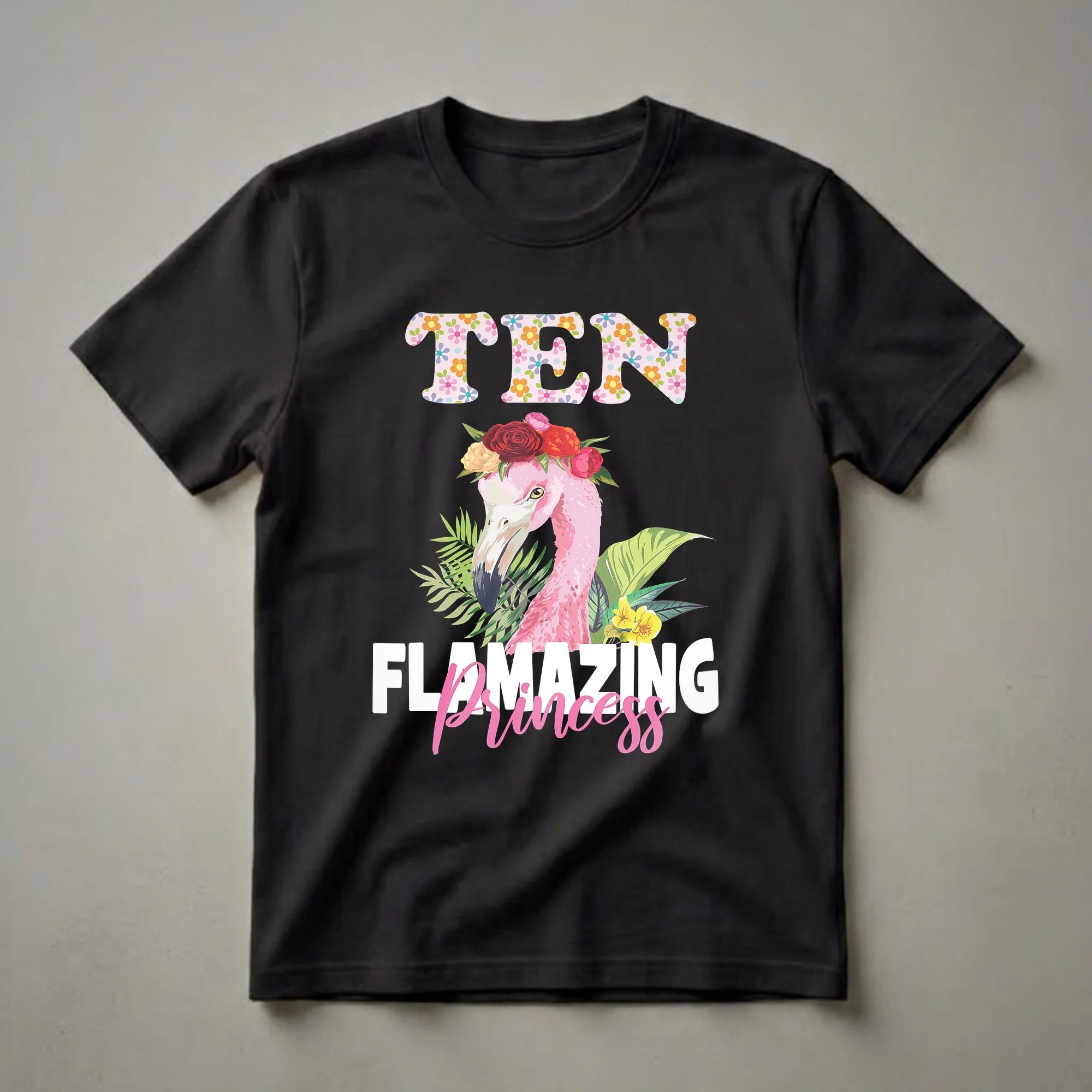White t-shirt with TEN in large floral-patterned block letters above a pink flamingo wearing a red and orange flower crown with tropical leaves, and Princess in pink script below.