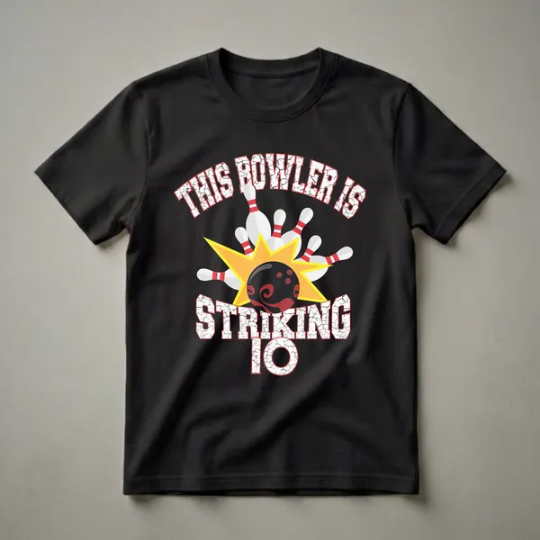 Black t-shirt with white and red text reading 'This Bowler Is Striking 10', featuring a bowling ball, pins, and a yellow starburst graphic.