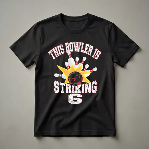 Black t-shirt with white distressed text 'THIS BOWLER IS STRIKING' and a graphic of a bowling ball hitting pins, with the number '6' below.