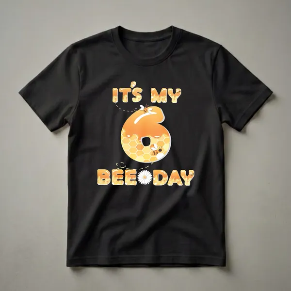 Black t-shirt featuring the text 'IT'S MY BEE DAY' and a large number '6', all with a honey and honeycomb design, adorned with bees and a daisy.