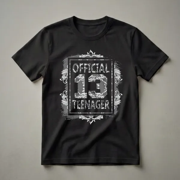 Black t-shirt with 'OFFICIAL 13 TEENAGER' graphic in grey and white, featuring ornate filigree and distressed brush stroke elements.