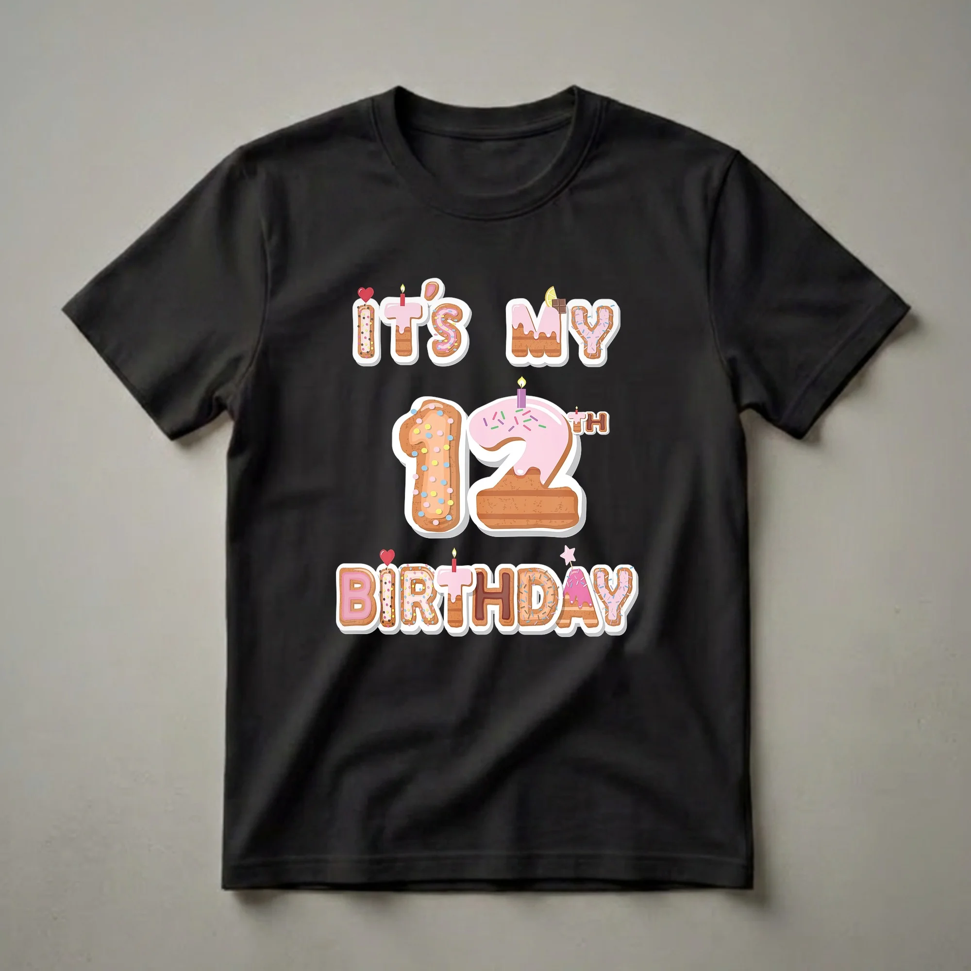 A graphic t-shirt design featuring the text "It's My 12th Birthday" in donut-themed letters and numbers, adorned with frosting, sprinkles, and birthday candles.