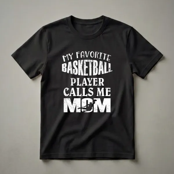 Black t-shirt with white distressed text that reads 'My Favorite Basketball Player Calls Me Mom' and a silhouette of a basketball player dunking.
