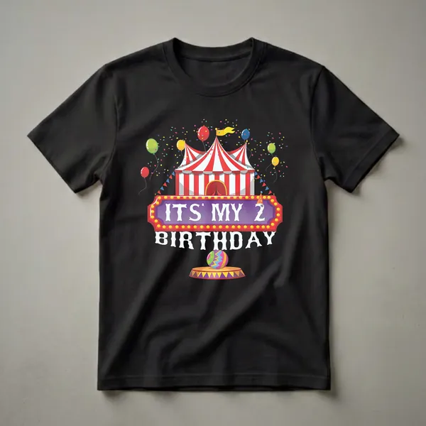 A black t-shirt graphic featuring a red and white striped circus tent, colorful balloons, confetti, and the text 'ITS MY 2ND BIRTHDAY' in a marquee style.