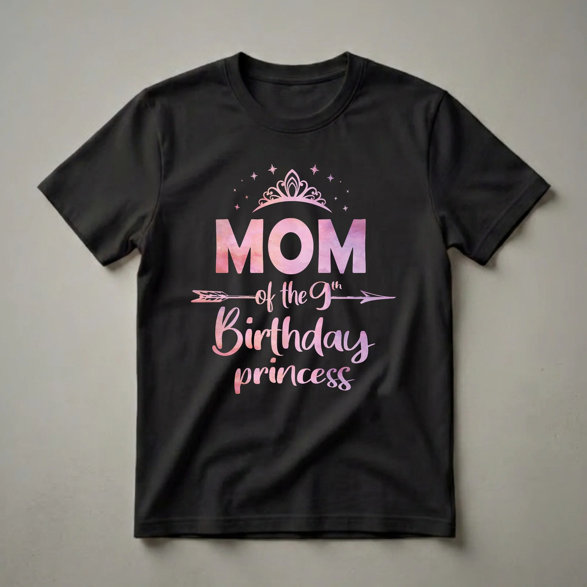 Black t-shirt with pink and purple watercolor text that reads 'MOM of the 9th Birthday princess', topped with a crown and stars, and a decorative arrow.