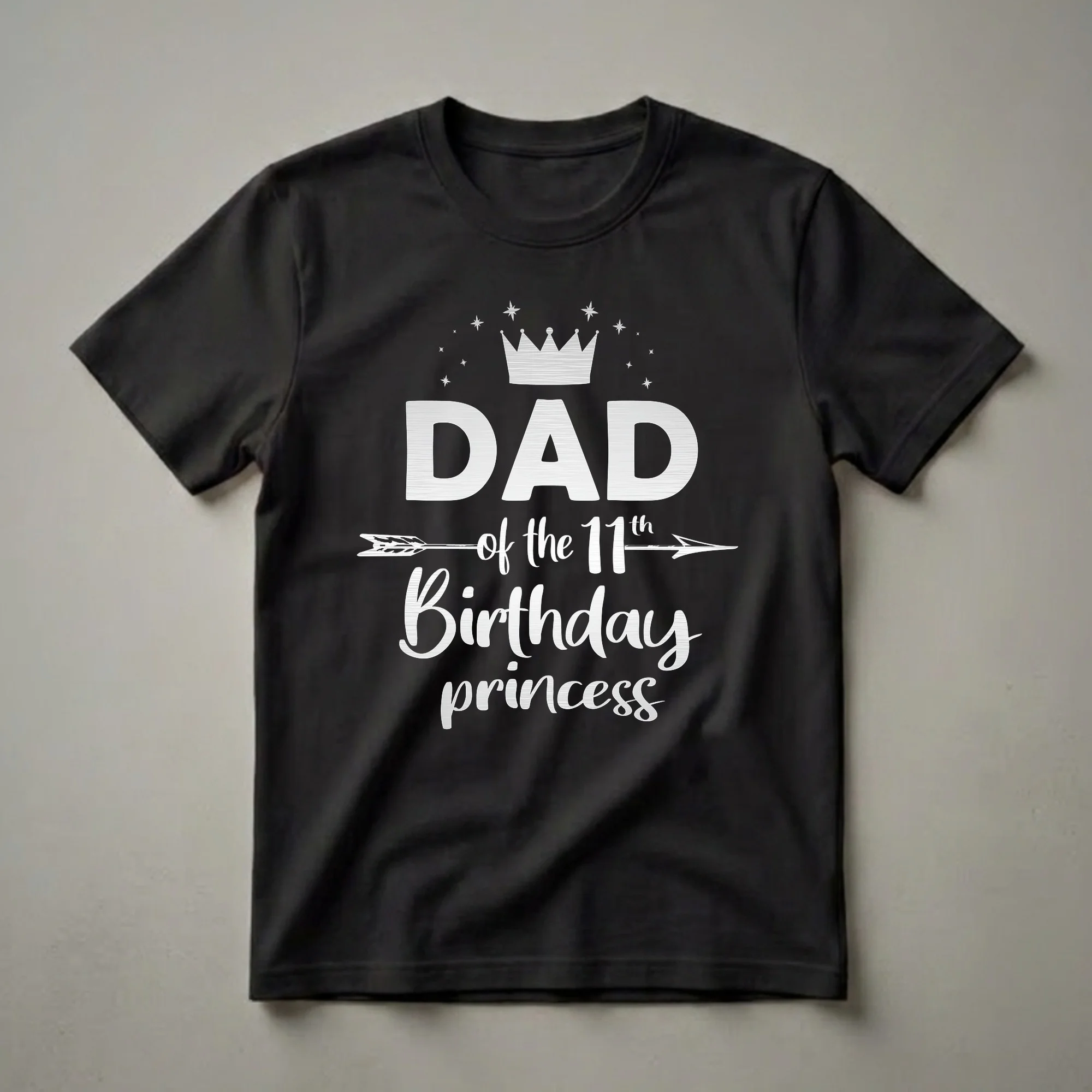 Black t-shirt with white graphic text that reads 'DAD of the 11th Birthday princess', featuring a crown and stars above and an arrow graphic.