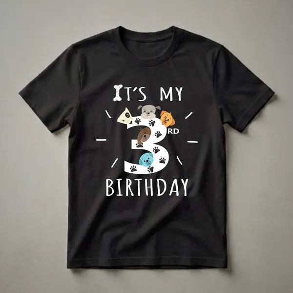 Black t-shirt with white text 'IT'S MY' and 'BIRTHDAY' surrounding a large white number '3' filled with cartoon dog faces and paw prints.