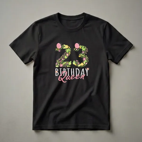 Black t-shirt with a large floral number 23 in pink, yellow, and green botanicals above BIRTHDAY in white block text and Queen in pink script.