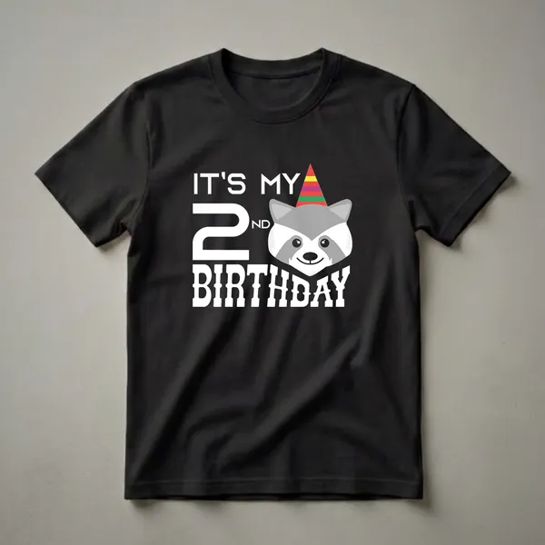 White graphic t-shirt with the text "IT'S MY 2ND BIRTHDAY" and a cartoon raccoon wearing a striped party hat.