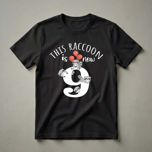 Black t-shirt with a graphic design featuring the number 9, multiple cartoon raccoons, red balloons, and the text 'THIS RACCOON is now'.